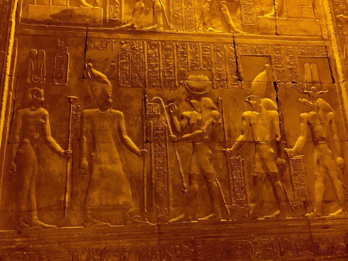 Ancient Egyptian temple carvings depicting religious and architectural significance