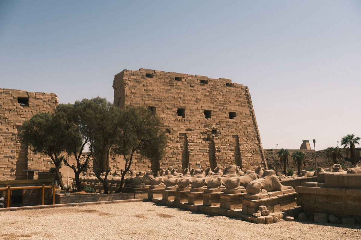 Karnak Temple facade with sun rays