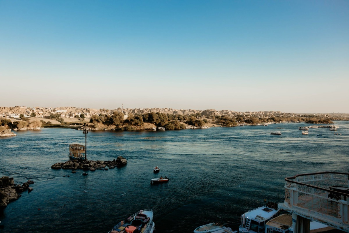 nile river at sunset with ancient temples in distance