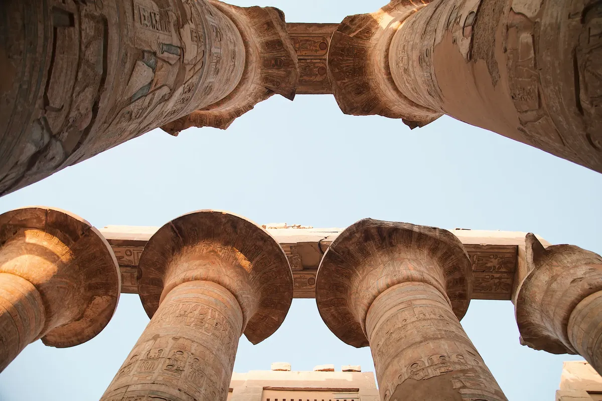 Upward view of ancient columns in Karnak Temple, Luxor, Egypt.