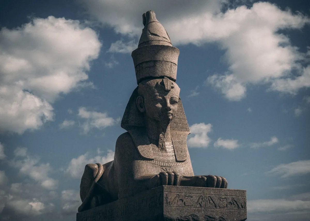 Ancient sphinx statue in Saint Petersburg with clouds in the background, highlighting historical art.
